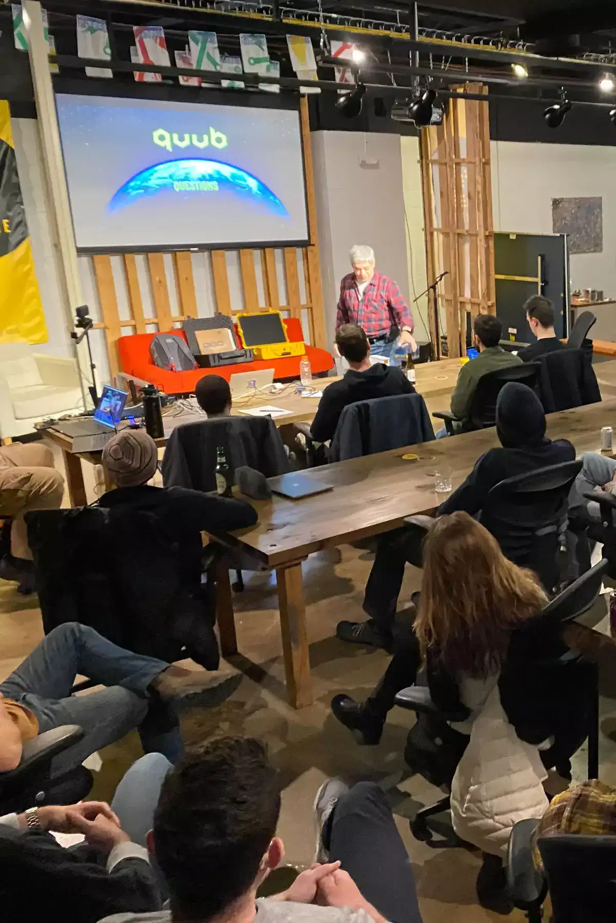 A picture of a dozen people attending a presentation at the Tech Lancaster meetup